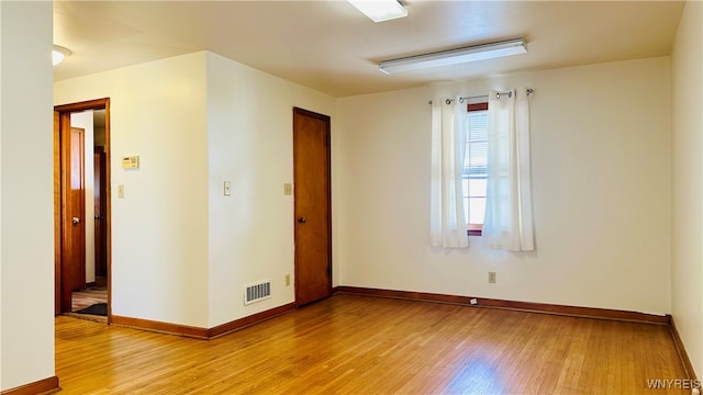 spare room with light hardwood / wood-style flooring