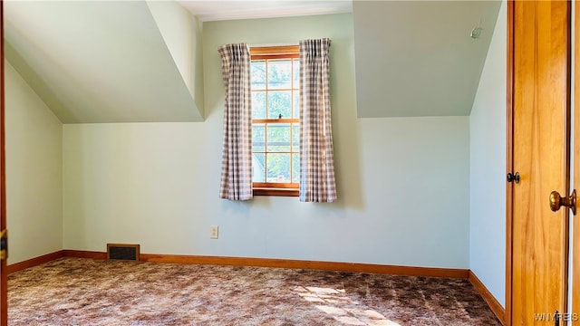 additional living space with lofted ceiling and carpet flooring