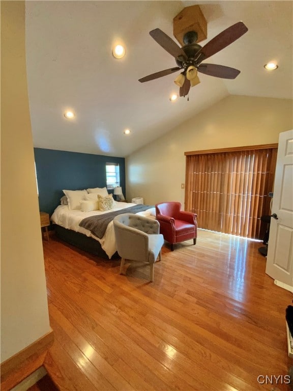 bedroom with ceiling fan, vaulted ceiling, and hardwood / wood-style flooring