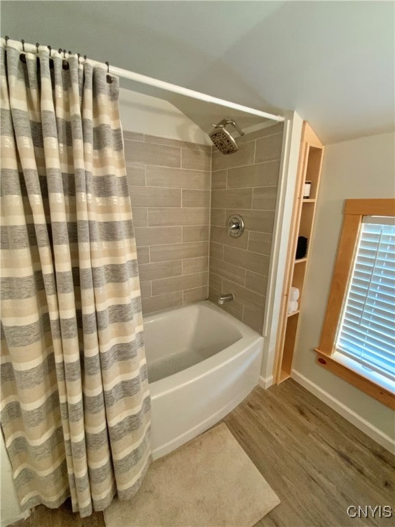 bathroom with wood-type flooring and shower / bath combo