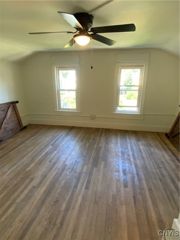 bonus room featuring lofted ceiling, hardwood / wood-style flooring, ceiling fan, and a healthy amount of sunlight