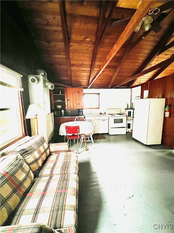 interior space with lofted ceiling with beams and wood ceiling