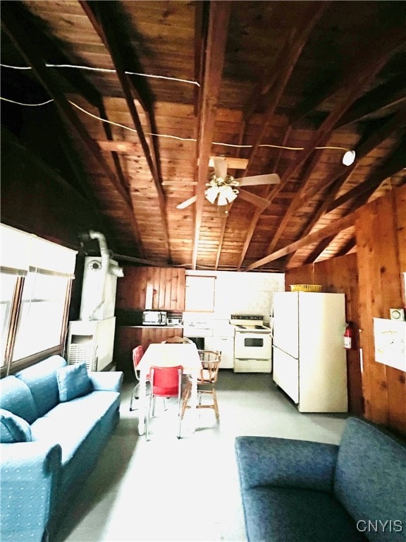 interior space featuring vaulted ceiling with beams, wooden walls, wooden ceiling, and ceiling fan