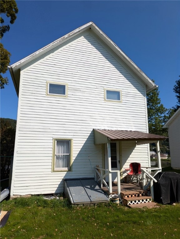 back of house featuring a lawn