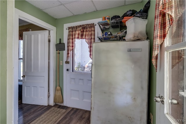 kitchen with dark wood-type flooring and a drop ceiling