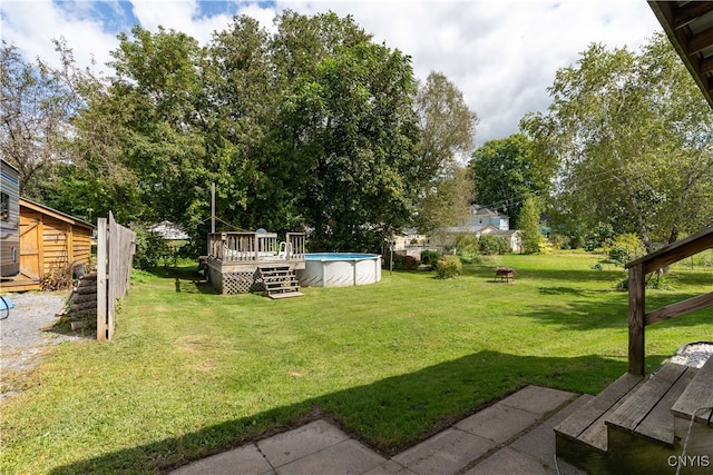 view of yard with a swimming pool side deck and a shed