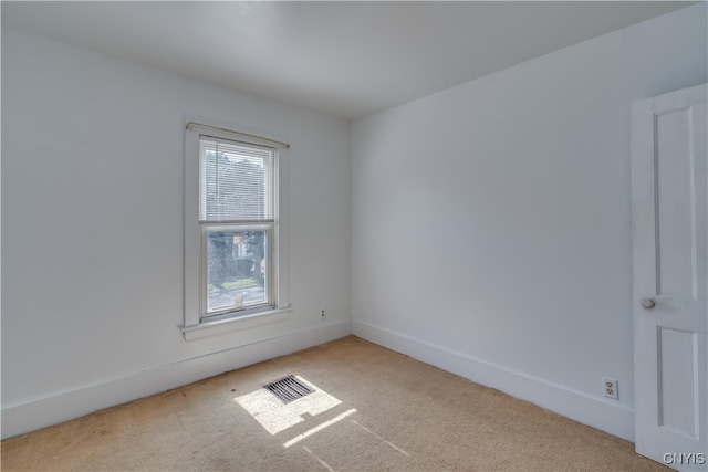 carpeted empty room with a healthy amount of sunlight