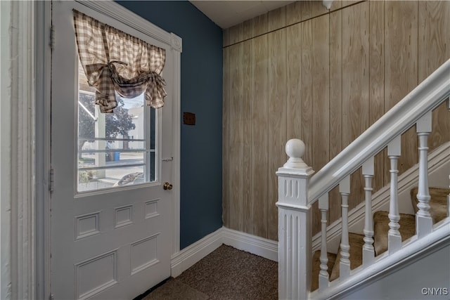 foyer entrance featuring wood walls