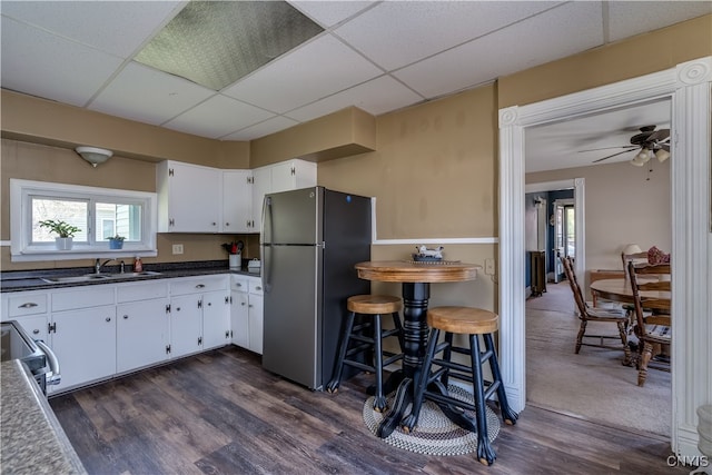 kitchen featuring white cabinetry, a paneled ceiling, stainless steel appliances, sink, and ceiling fan