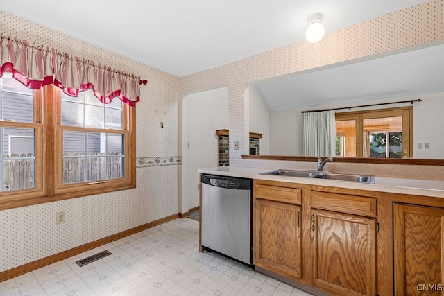 kitchen featuring plenty of natural light, stainless steel dishwasher, and sink