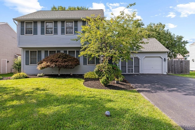 view of front of property with a garage and a front lawn