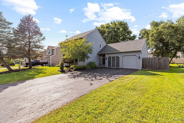 view of front of property with a garage and a front lawn