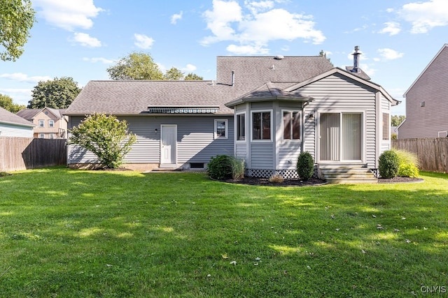 back of house featuring a yard