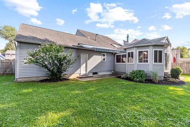 rear view of property with a yard