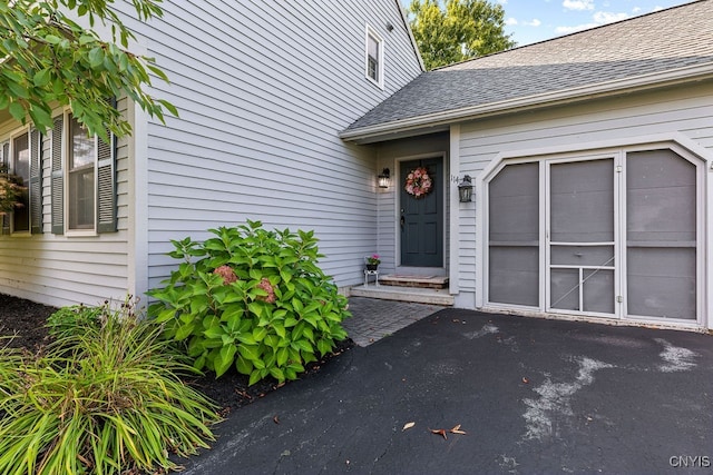 view of exterior entry with a garage