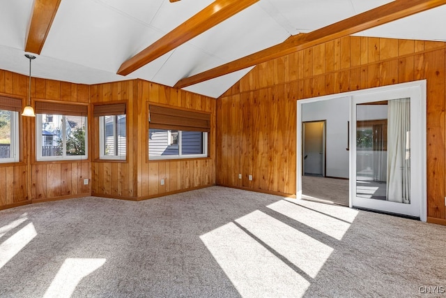 unfurnished living room with light carpet, wood walls, and vaulted ceiling with beams