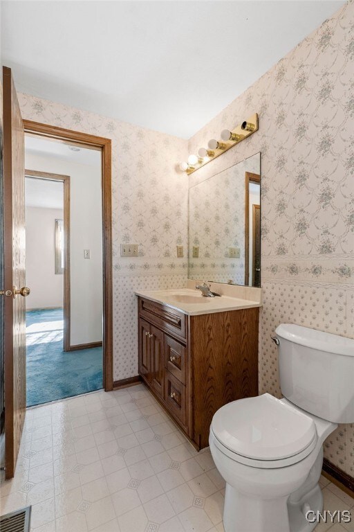 bathroom with vanity and toilet