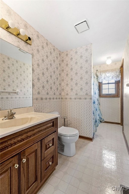 bathroom featuring vanity, toilet, a shower with curtain, and tile patterned floors