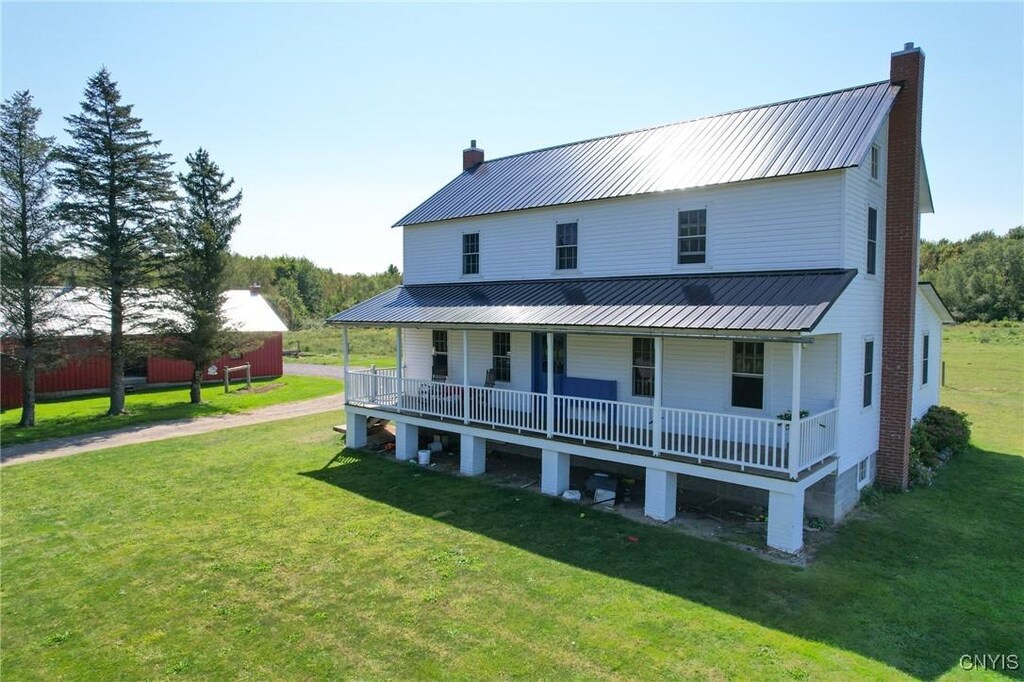 759 Bull Run Rd, Albion, NY 13142 - back of property with a porch, a yard, metal roof, and a chimney