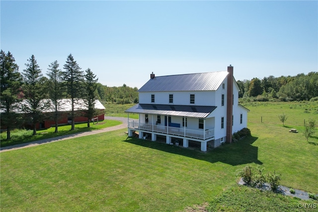 back of property featuring a lawn