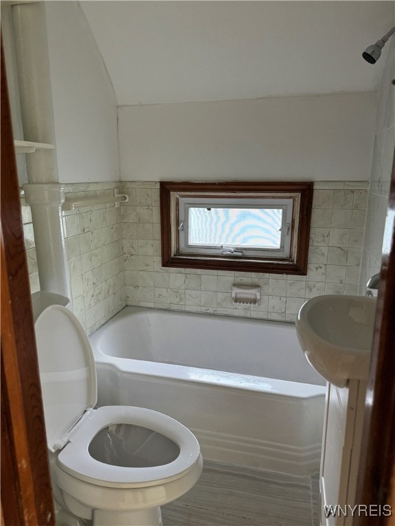 bathroom featuring shower / bathtub combination and toilet