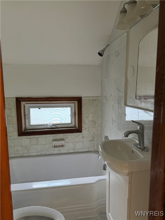 full bathroom with washtub / shower combination, toilet, and vanity