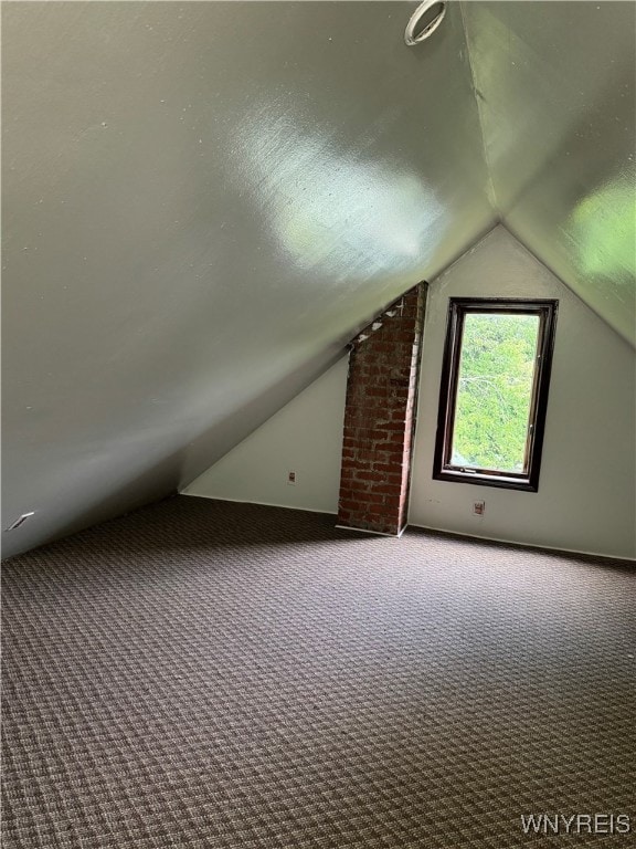 bonus room featuring lofted ceiling and carpet