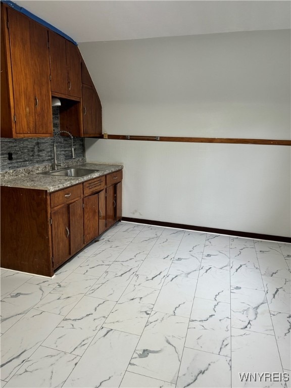 kitchen with lofted ceiling and sink