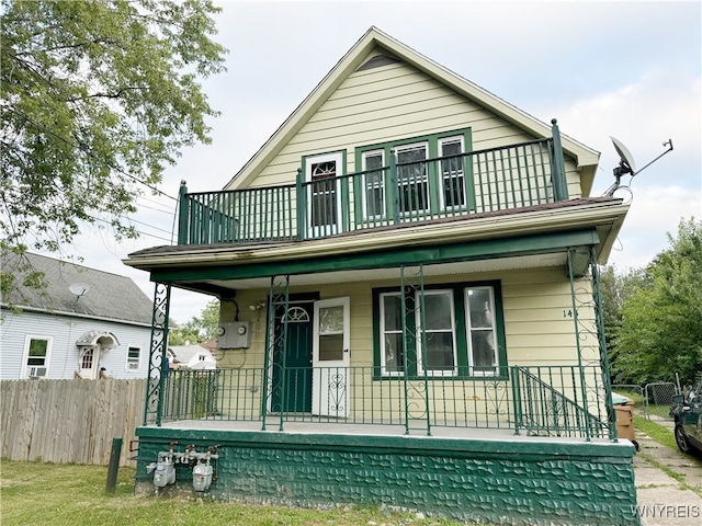 rear view of house featuring covered porch