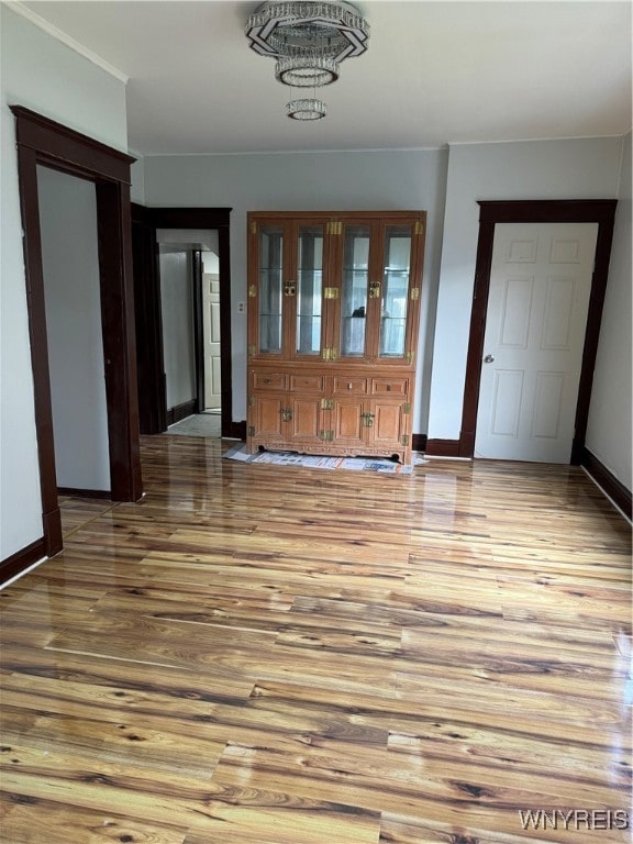 foyer entrance with an inviting chandelier and wood-type flooring