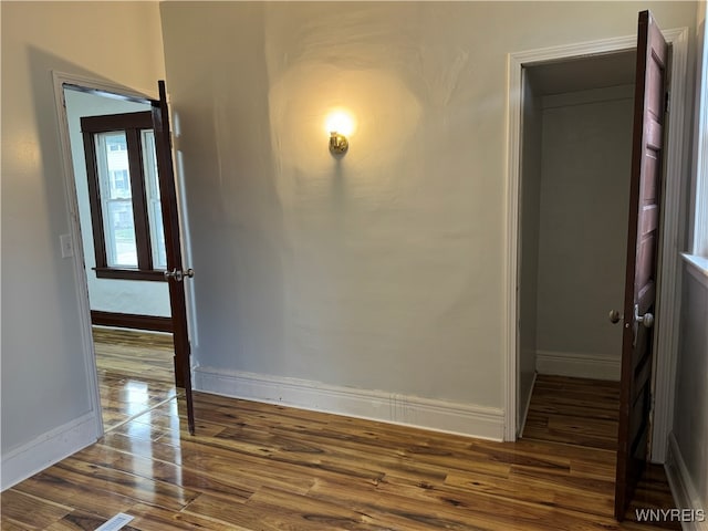 unfurnished room featuring dark wood-type flooring