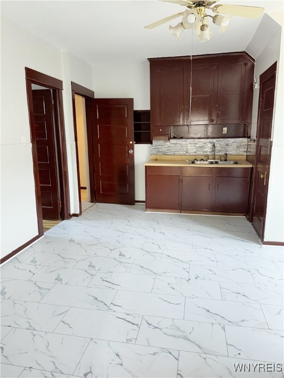 kitchen with ceiling fan, sink, and tasteful backsplash