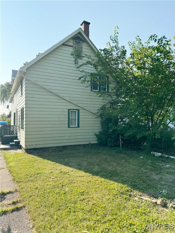 view of property exterior featuring a yard