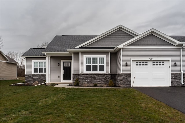 craftsman inspired home featuring a garage and a front yard