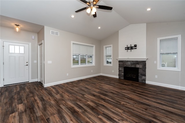 unfurnished living room featuring lofted ceiling, dark wood-type flooring, ceiling fan, and a fireplace