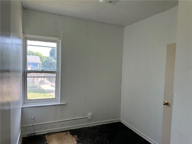 spare room with a textured ceiling and a healthy amount of sunlight