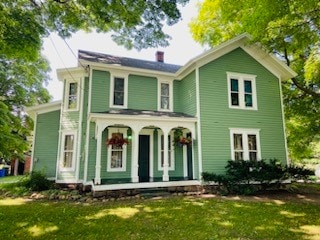 view of front facade with a front yard and a porch