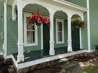 doorway to property featuring a porch