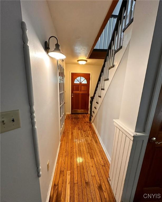 205 S James St, Wilna, NY 13619 - corridor featuring hardwood / wood-style floors, baseboards, and stairway