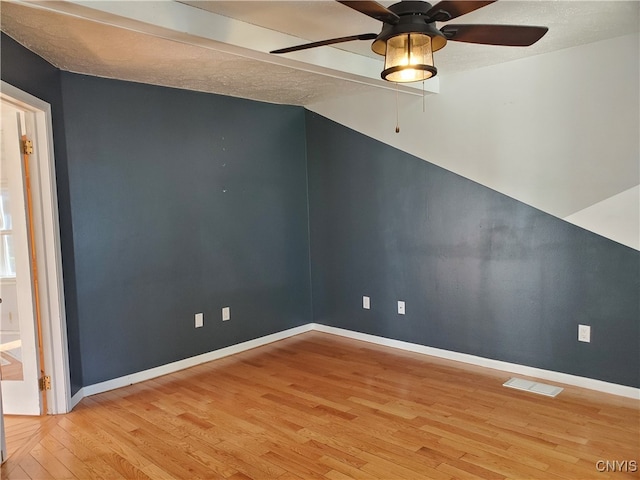 unfurnished room with a textured ceiling, hardwood / wood-style floors, and ceiling fan