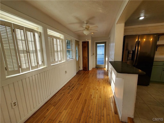 205 S James St, Wilna, NY 13619 - kitchen featuring fridge with ice dispenser, dark countertops, a ceiling fan, light wood finished floors, and a textured ceiling
