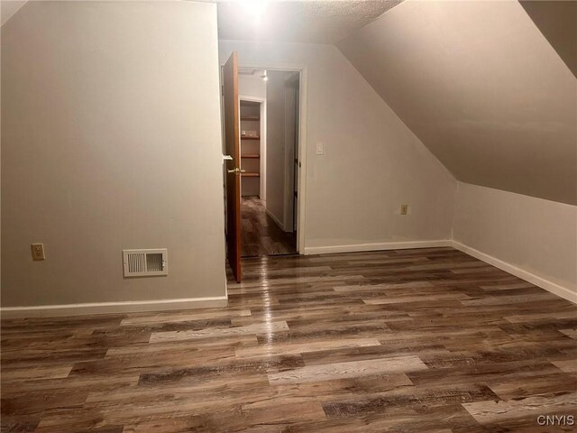 205 S James St, Wilna, NY 13619 - bonus room with dark wood-style flooring, lofted ceiling, and baseboards