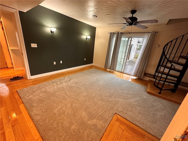 interior space with hardwood / wood-style floors, ceiling fan, and a textured ceiling