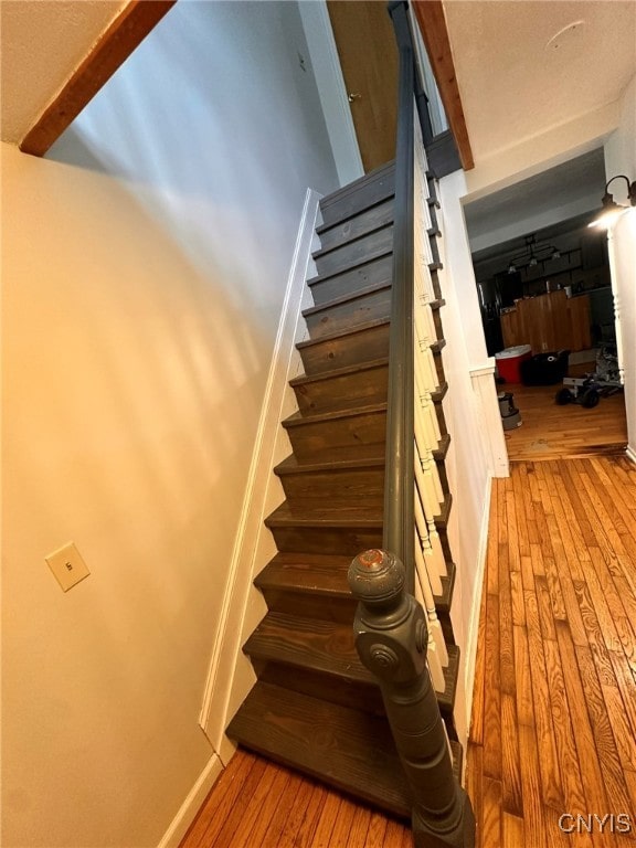 stairway featuring hardwood / wood-style floors