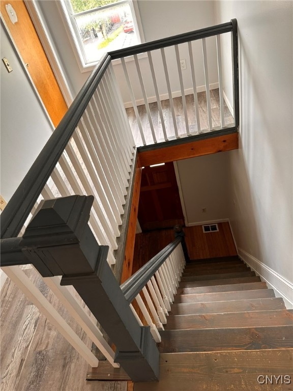 stairway with hardwood / wood-style floors