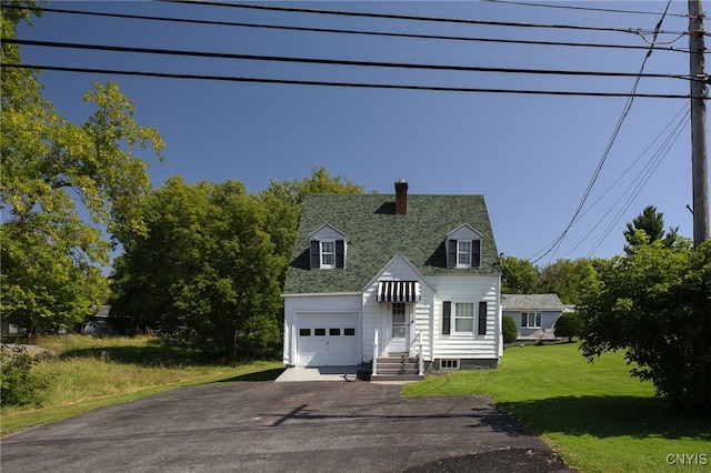 view of front of property featuring a garage and a front yard