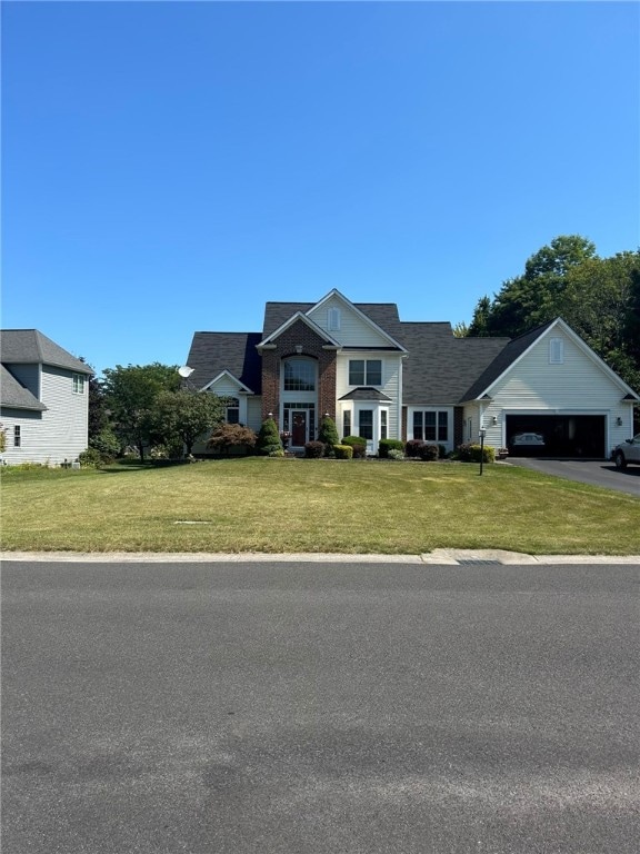 view of front of property featuring a front lawn and a garage