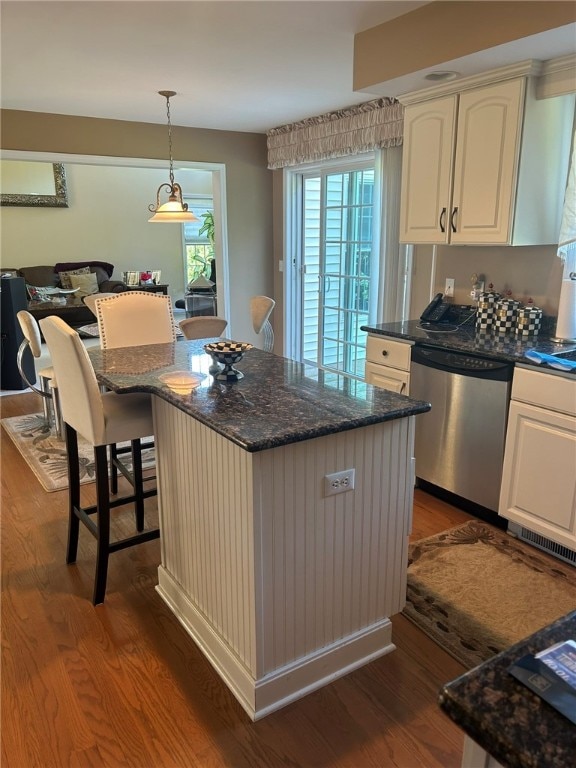 kitchen featuring dishwasher, a center island, a wealth of natural light, and dark wood-type flooring