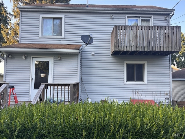 back of property featuring a balcony