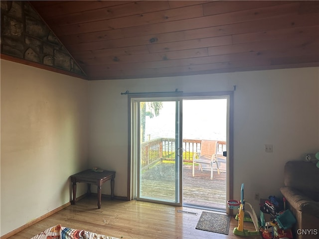 doorway with light hardwood / wood-style floors, lofted ceiling, and wooden ceiling